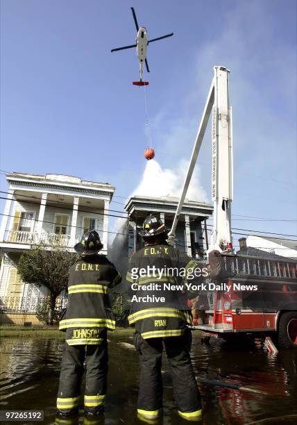 Firefighters Ken Johnson and Chris Ryan, of Ladder 146 in Brooklyn, are on the scene at a fire in New Orleans, Louisiana as they and some 300 other...