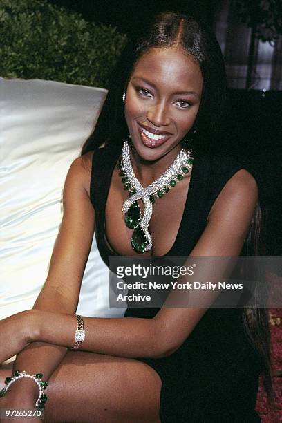 Model Naomi Campbell wears a Cartier emerald-and-diamond snake necklace, adding up to more than 400 carats in emeralds, at a Cartier dinner party.