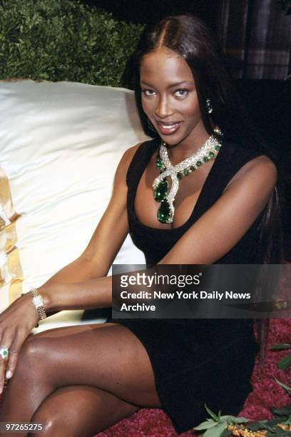 Model Naomi Campbell wears a Cartier emerald-and-diamond snake necklace, adding up to more than 400 carats in emeralds, at a Cartier dinner party.