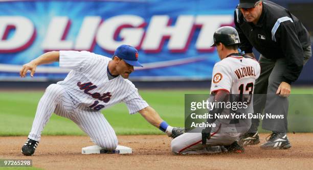 New York Mets' shortstop Jose Valentin tags out San Francisco Giants' Omar Vizquel at second in the first inning of a game at Shea Stadium. The Mets...