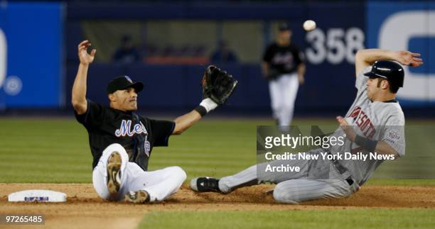 New York Mets' second baseman Jose Valentin slips and falls as Minnesota Twins' Justin Morneau steals second in the fifth inning of a game at Shea...