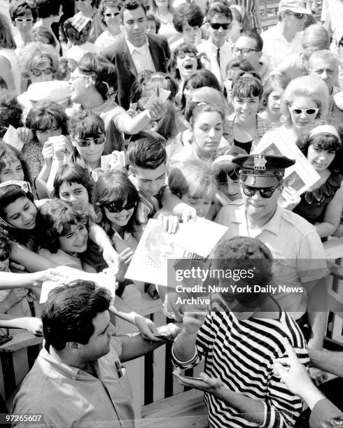 Bobby Vinton, recording star, is mobbed by autograph seekers after one of free shows which helped to draw millions to Palisades Amusement Park.