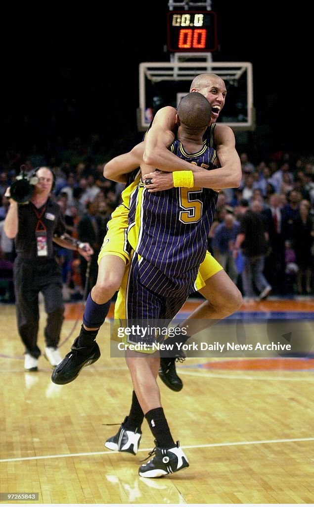Indiana Pacers' Jalen Rose carries teamate Reggie Miller aft