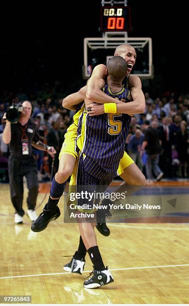 Indiana Pacers' Jalen Rose carries teammate Reggie Miller after defeating the New York Knicks, 93-80, in Game 6 of the Eastern Conference finals at...