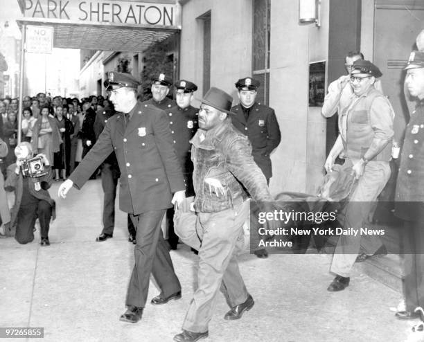 Body of Albert Anastasia is taken from the Park Sheraton and placed in morgue wagon, after being shot in hotel's barber shop.