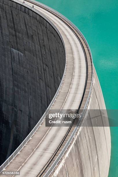 people walking on edge of stausee mooserboden dam, kaprun, austria - stausee stock pictures, royalty-free photos & images