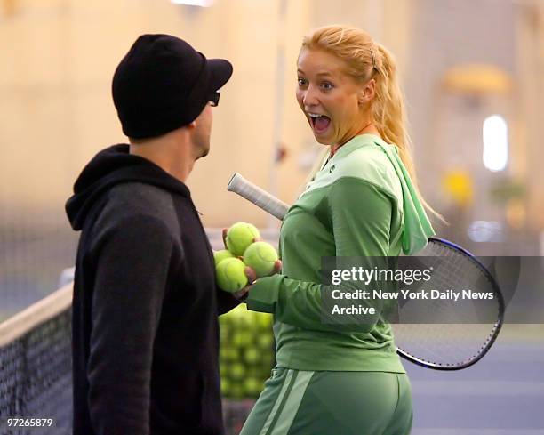 Russian tennis player and model Olga Poutchkova lets out a laugh as she talks to coach Bruce Haddad at the Stadium Racquet Club in the Bronx.