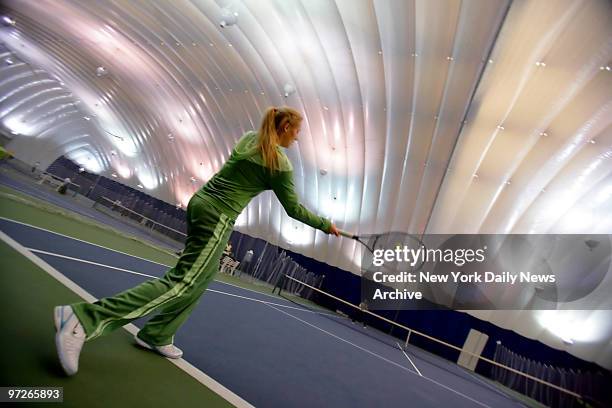 Russian tennis player and model Olga Poutchkova takes some practice swings on one of the bubbled courts at the Stadium Racquet Club in the Bronx.