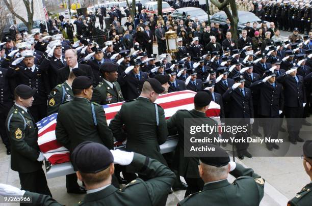 Fellow firefighters and soldiers salute as the flag-draped coffin of Christian Engeldrum is carried from St. Benedict's Church in the Bronx following...