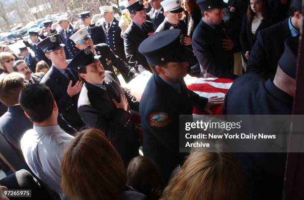 Fellow firefighters carry the flag-covered coffin of Lt. Glen Perry into St. Mary's church in Washingtonville, N.Y. Perry's son, Glenn, a 17-year-old...