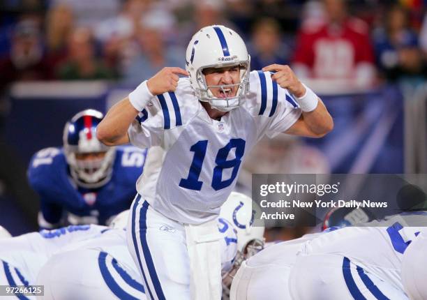 Indianapolis Colts' quarterback Peyton Manning calls out plays on the line during the first half of a game against the New York Giants at Giants...