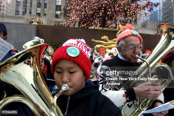 Colin Bassett from Allendale, N.J., and George Wenderoth from Wayne, N.J., join hundreds of musicians in the 28th annual Tuba Christmas holiday...