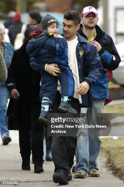 Colin Farrell carries Ty Simpkins on Leggett Place in Whitestone, Queens, where they are filming scenes for their new movie "Pride and Glory."...