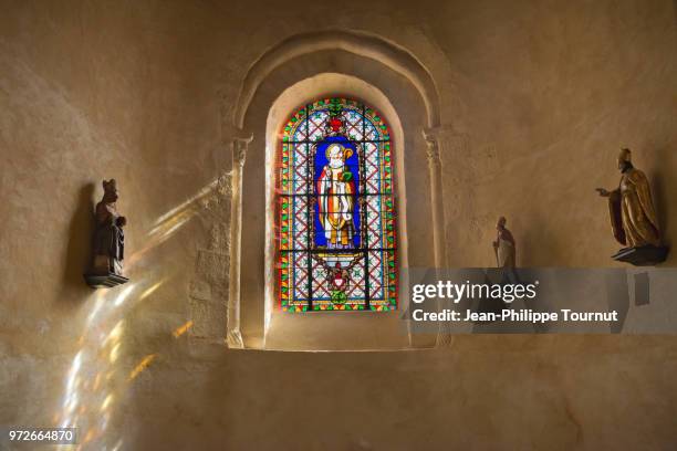 stained glass window of saint martial, monastery of st. valerie in chambon sur voueize, abbatiale sainte valérie, creuse, france - town of the gods stock-fotos und bilder