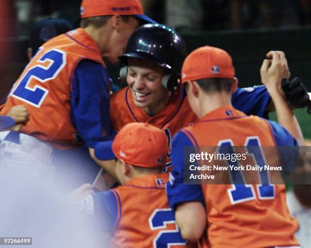 Ryan Griffin is mobbed by his Worcester, Mass., teammates after crossing the plate following his three-run, walk-off homer in the sixth inning...