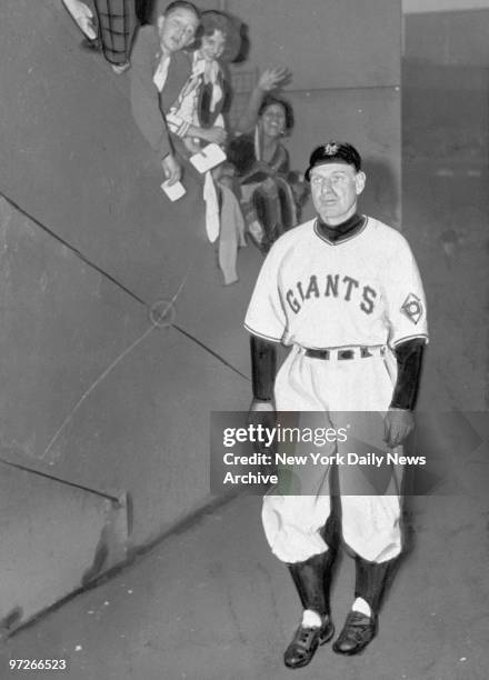 Leo Durocher walking off a baseball field after Giants' Bobby Thomson hit a 3-run homer off Dodgers' Ralph Branca as the Giants defeated the Dodgers...