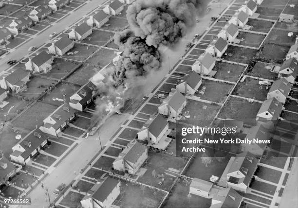 Bomber Crashes in Street. A B-26 bomer burns furiously in street and on lawn outside 61 Barbara Drive in East Meadow, L.I.. Causing auto and home to...