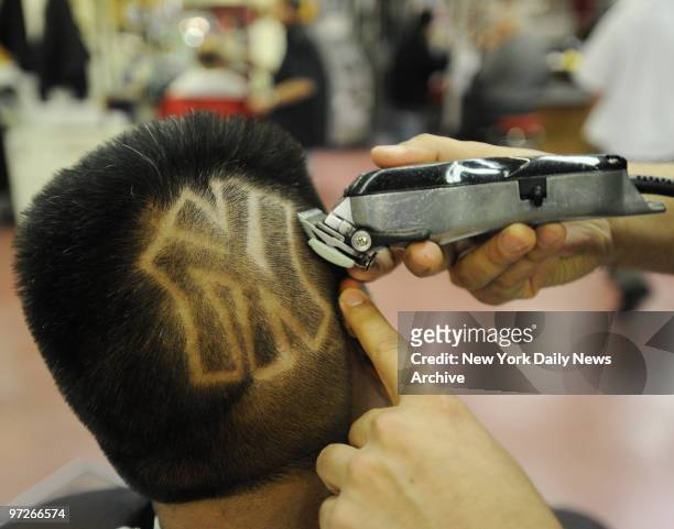 Bombers fan Luis Romero gets the iconic team logo haircut at Astor Place Hair Designers in the East Village. The cut costs $40 and takes about 25...