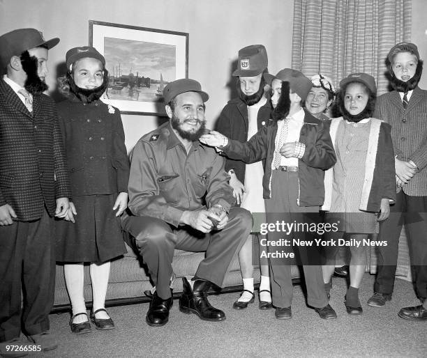 Fidel Castro has his beard admired during a visit to his hotel by youngsters who attended a Queens school with his son. The boy was secretly living...