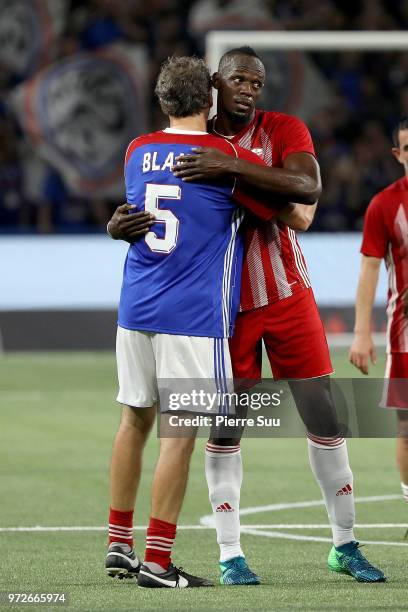 Sprinter Usain Bolt is seen with Laurent Blanc during the France 98 versus Fifa 98 football match at U Arena on June 12, 2018 in Nanterre, France.