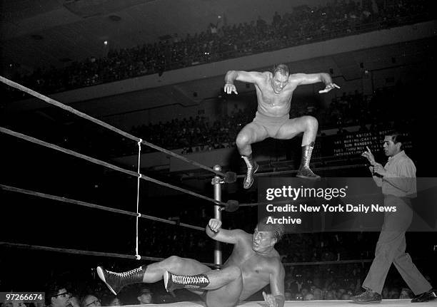 Like a hawk after a chicken, Killer Kowalski pounces on Buddy Rogers.