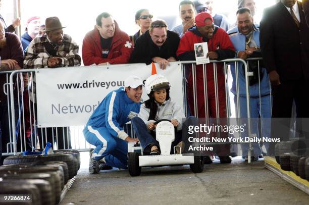 Indy race car driver Danica Patrick prepares to take on actor Tony Danza in a go-kart race sponsored by Network Solutions to promote National...