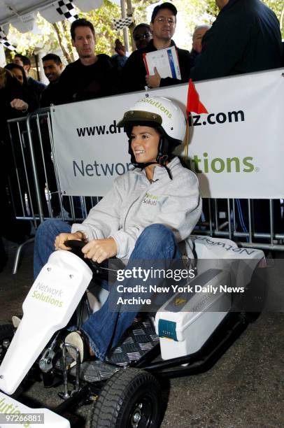 Indy race car driver Danica Patrick sits in a go-kart as she prepares to take on actor Tony Danza in a race sponsored by Network Solutions to promote...