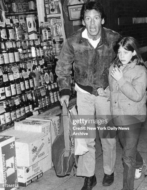 Calvin Klein leads his daughter Marci away from the house on 97th St. Where she was released.