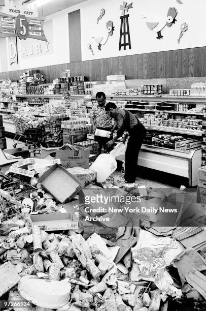 Interior of the Food City supermarket at Walton Ave. And East Burnside Ave. In the Bronx with spoiled food and looted discards as clerks restock the...