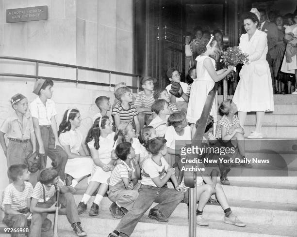 Sad faced kids watch Marian Duffy of 430 E. 65th St., give bouquet to nurse Pauline Newman for the ailing Bambino Babe Ruth who is in critical...