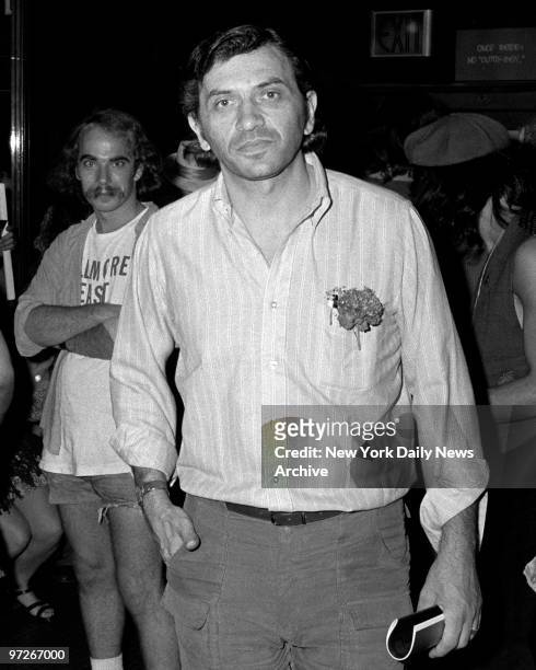 Fillmore East owner Bill Graham walks glumly in lobby. A set of modern-day longhairs fill Second Avenue between Sixth and Seventh Streets, as rock...