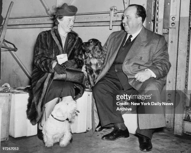 Film director Alfred Hitchcock with his wife and dogs. Hitchcock's movie "The Lady Vanishes" had won a New York Film Critics Circle Award..