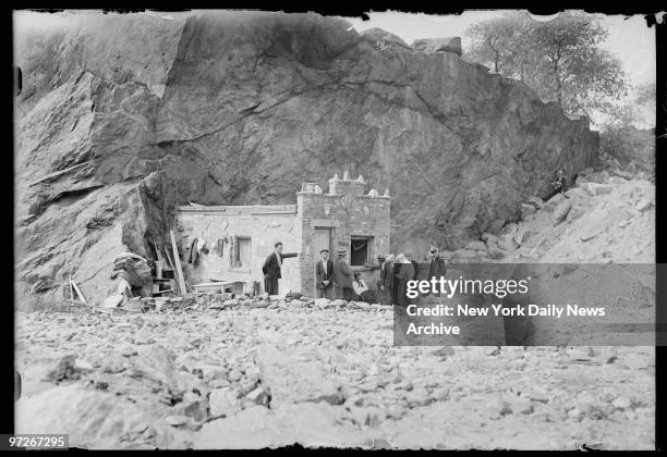 Inhabitants of Hooverville gather outside the Mansion, town's chief edifice, which snuggles in lee of rocky cliff to protect it from wintry winds.