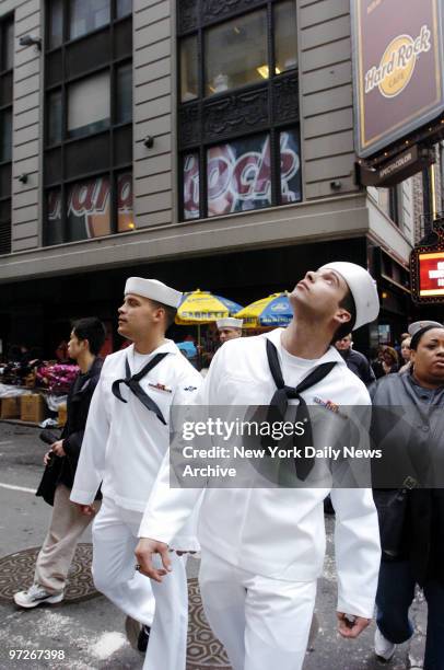 Sailors Jeff Baker and Walter Griffin of the USS John F. Kennedy take in the scenery as they sightsee in Times Square. They're among thousands of men...