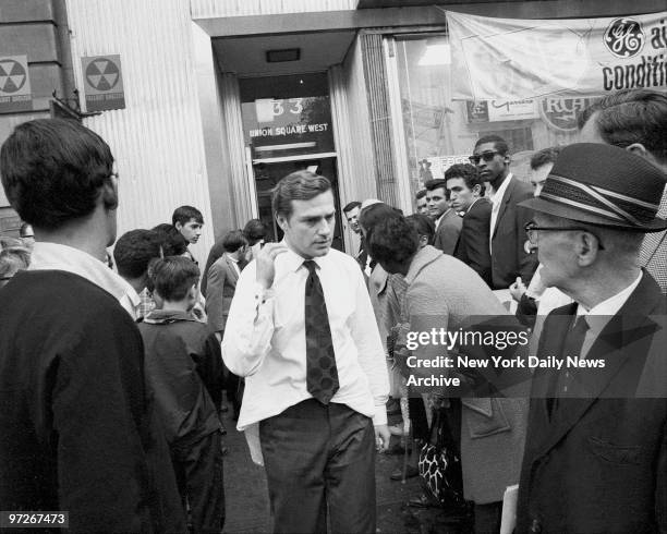 Moments after Andy Warhol was critically shot at his 33 Union Square office, his associate, Mario Amaya, walks to ambulance with back wound. Bullet...