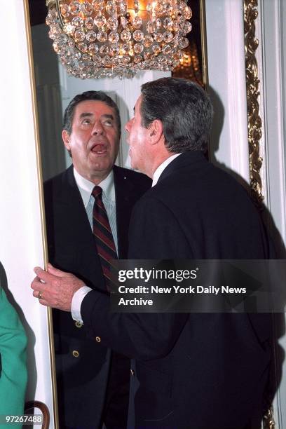 Comedian Jerry Lewis clowns around in the mirror during the Drama League annual awards at the Plaza Hotel. ,