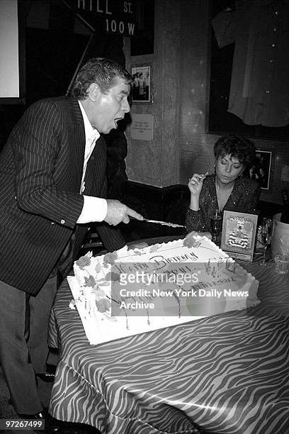 Comedian Jerry Lewis cuts his cake as his wife, Sam, looks on during celebration of his 69th birthday at Planet Hollywood.