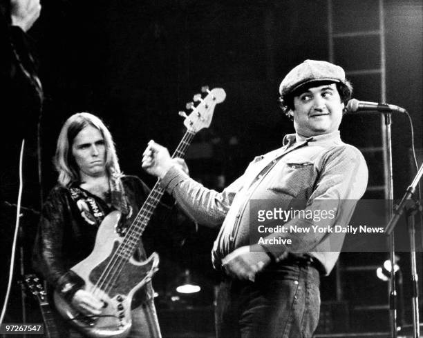 Comedian John Belushi clowns on stage with the Allman Brothers Band during concert at the Capitol Theater.