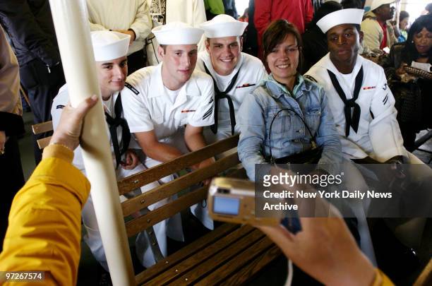 Sailors on shore leave from the USS Cape St. George - BM3 Mark Ezzo, SN Shaun Reagan, SN Brendan Mosey and SA Jason Jones - pose for photographs with...