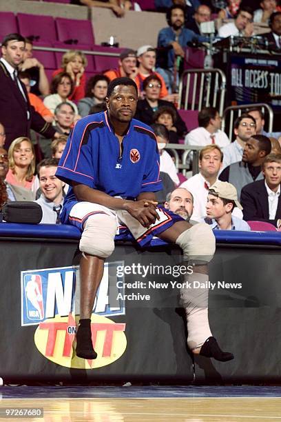 Injured New York Knicks' Patrick Ewing watches from the sidelines as clock winds down in game against the Miami Heat at Madison Square Garden.