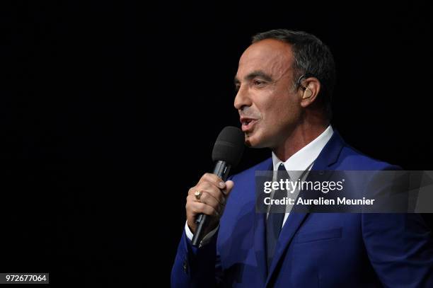 French tv host Nikos Aliagas speaks on tv during the players presentation before the friendly match between France 98 and FIFA 98 at U Arena on June...