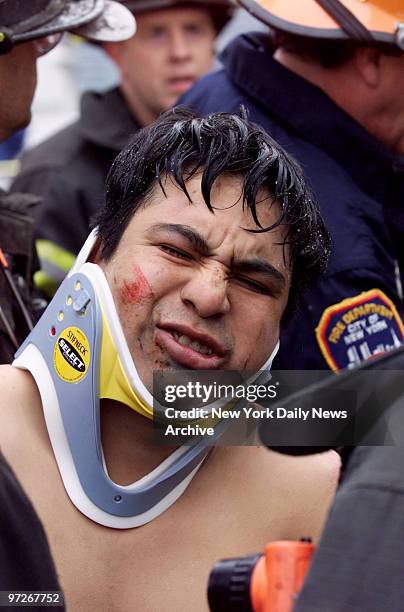 Injured worker is treated at scene of disaster at Middleton St. In Williamsburg, Brooklyn. A worker died when he was buried alive and 12 were hurt...