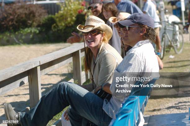 Bruce Springsteen, toting a camera, and wife Patti Scialfa watch from the stands as their daughter, Jessica Springsteen, competes at the 30th annual...