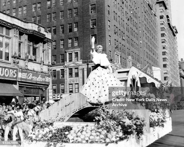 Film star Ginger Rogers looked festive on flower float at the Macy's Thanksgiving Day parade.