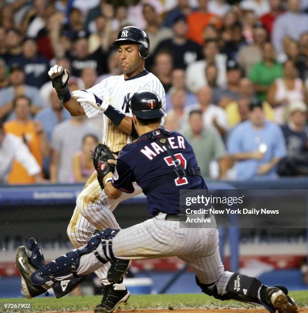 New York Yankees' Derek Jeter is tagged out at home base by Minnesota Twins catcher Joe Mauer. Minnesota won, 7-3, at Yankee Stadium.