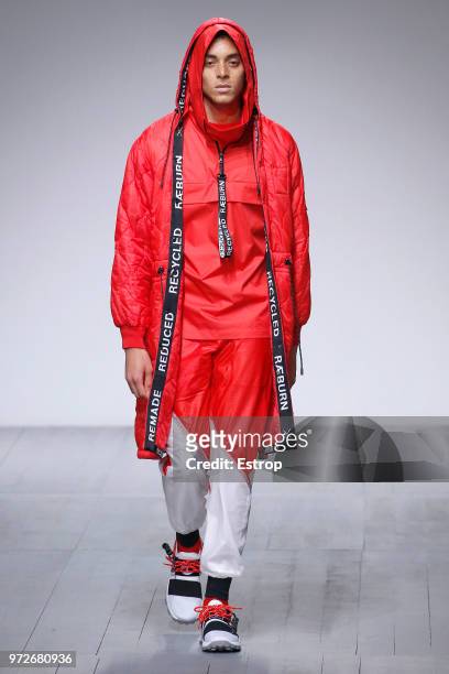 Model walks the runway at the Christopher Raeburn show during London Fashion Week Men's June 2018 at the BFC Show Space on June 10, 2018 in London,...
