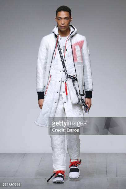 Model walks the runway at the Christopher Raeburn show during London Fashion Week Men's June 2018 at the BFC Show Space on June 10, 2018 in London,...