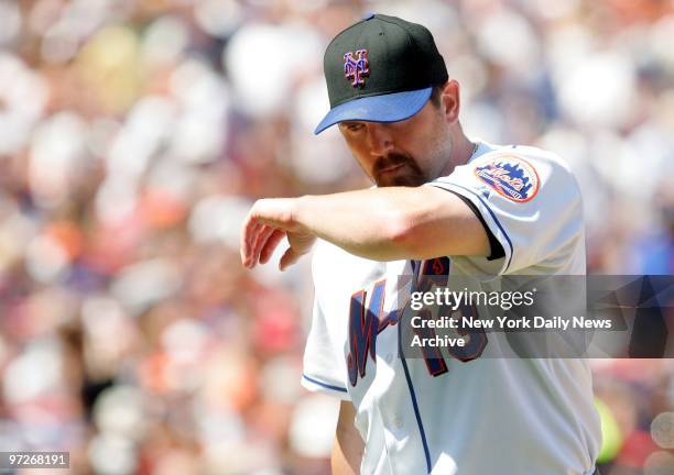 New York Mets' starter Matt Ginter wipes his face as he's taken out in the fourth inning of game against the New York Yankees at Shea Stadium. The...