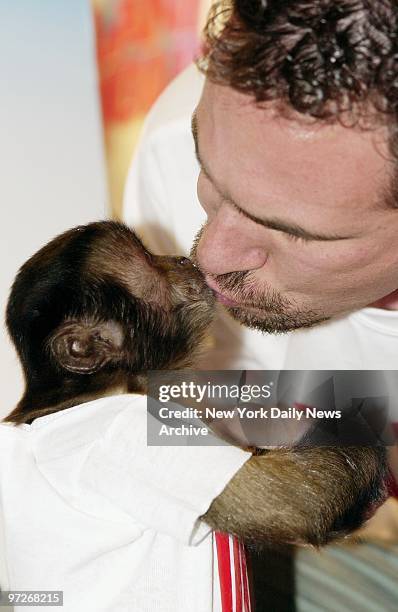 Monkey business is on the agenda at Planet Hollywood where Crystal rewards trainer Tom Castiglione with a kiss. They were on hand to plug the...