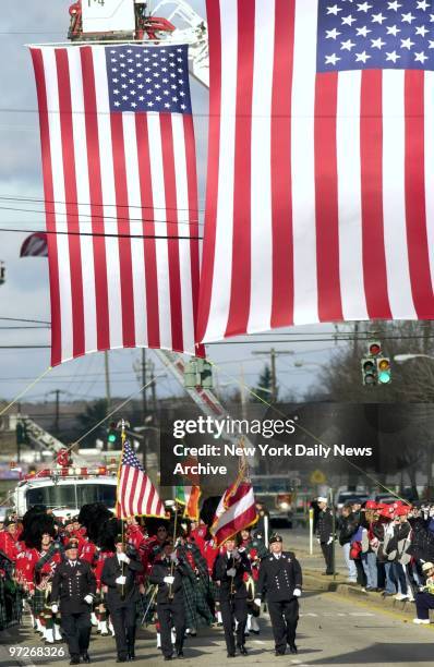 Fire Dept. Pipe band leads procession of firefighters and fire trucks during memorial service for Deputy Chief Raymond Downey at Sts. Cyril and...